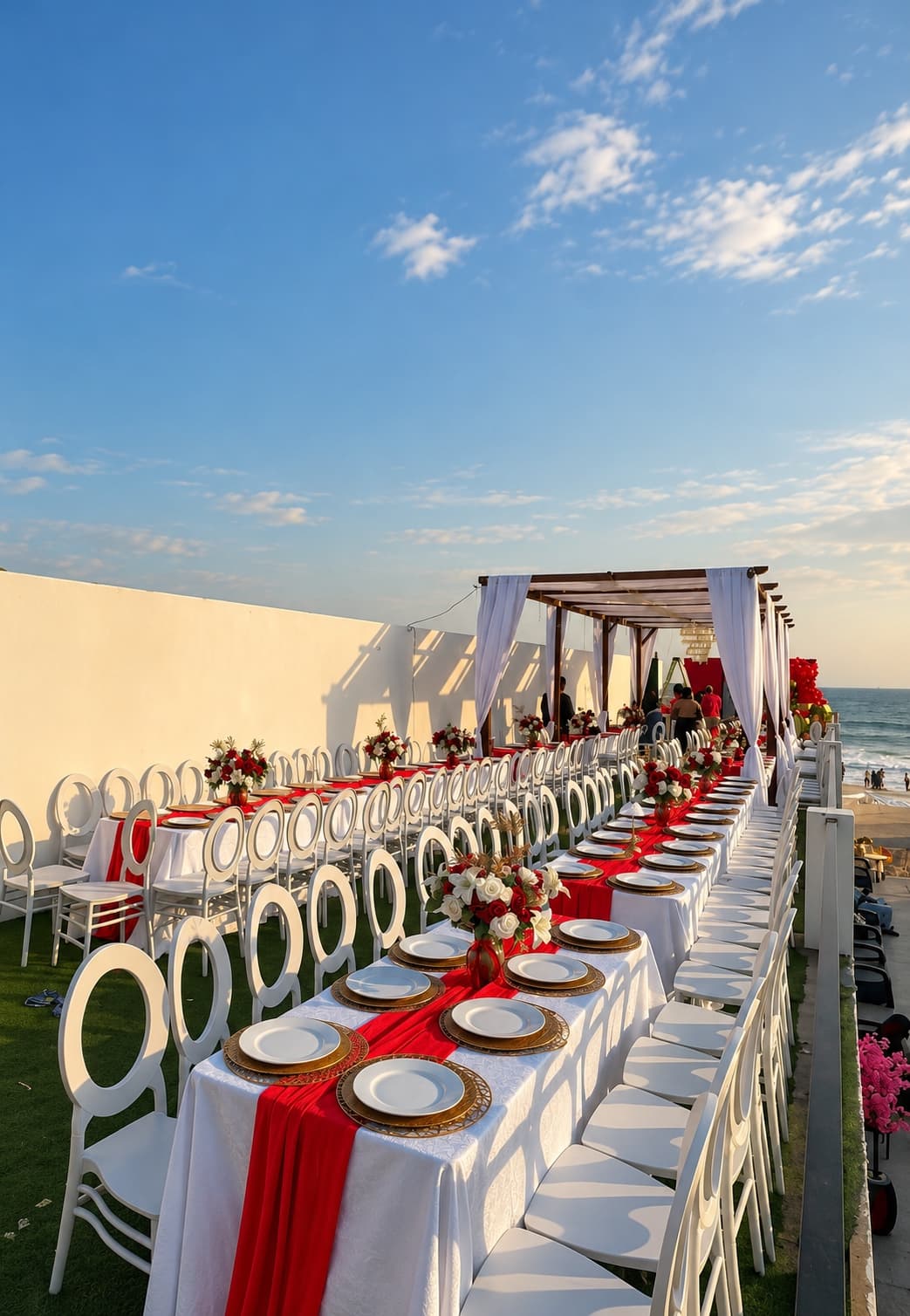 Sophisticated event tablescape with red and white floral arrangements and elegant tableware